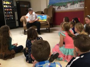 Collinsville Fire Chief Kevin Edmond reads to children at Young Authors Tea