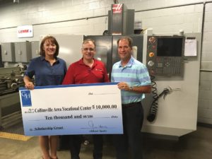 CAVC Director Tricia Blackard and CHS Principal David Snider Accept Check from Haas Machines Rep