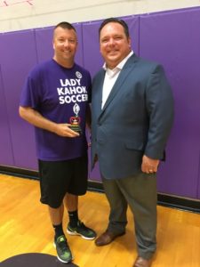 Clay Smith Accepts Teacher of the Month award from Jason Rehg