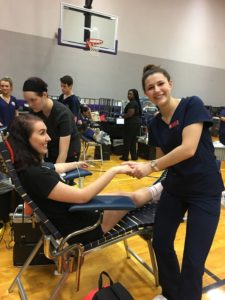 CHS Nursing Students holding hand or girl giving blood