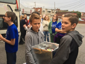Collinsville Middle School Students Carry Box into Food Pantry