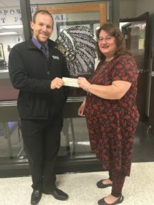 Beth Bancroft presents $1000 check to CHS band director Robert Wright