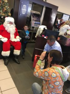 Boy being photographed with Santa