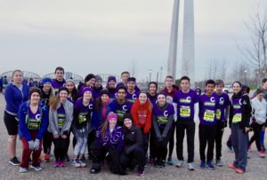 CHS Go St. Louis Half Marathon participants posed in a group photo by the Arch