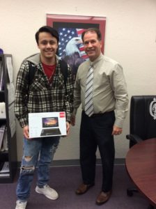 Student received notebook computer from CHS Principal David Snider