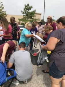 CMS Staff Handing out School supplies