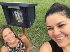 Sarah Gray and Lisa Garcia with Little Free Library box